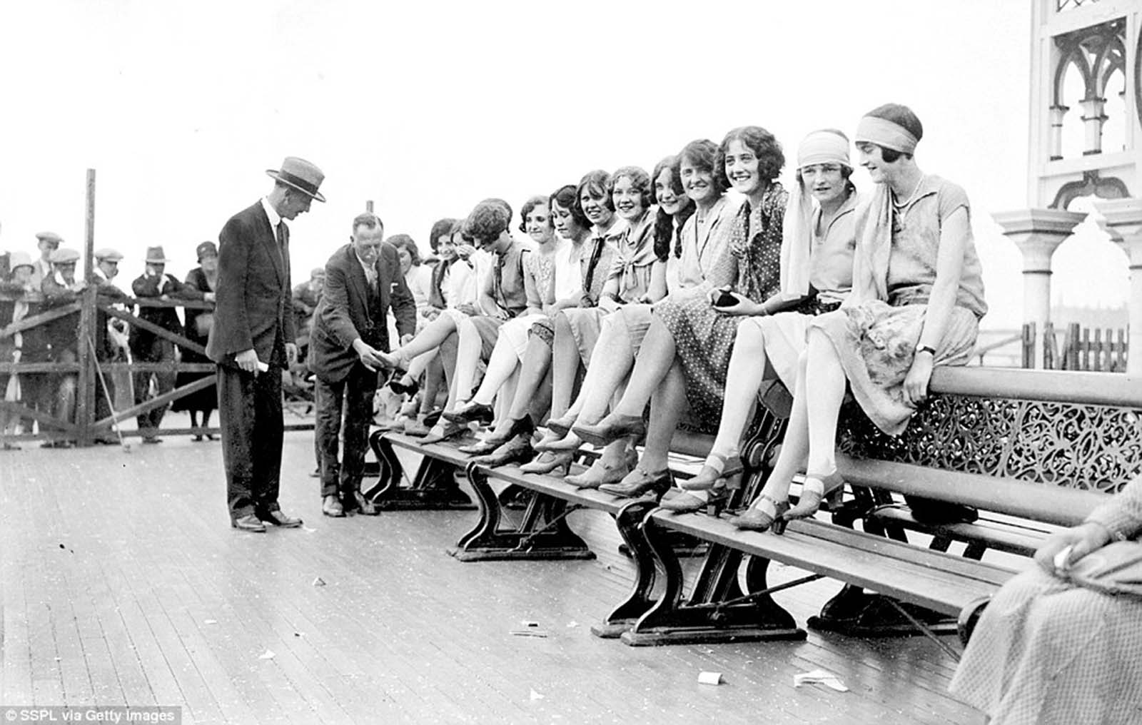 Judges judging ankles in the most beautiful ankles competition held on Palace Pier in connection with the Brighton carnival celebrations.