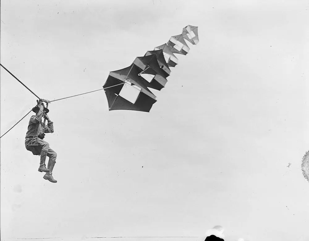 Vintage man lifting kites 
