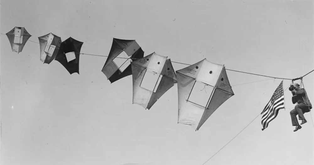 Vintage man lifting kites 