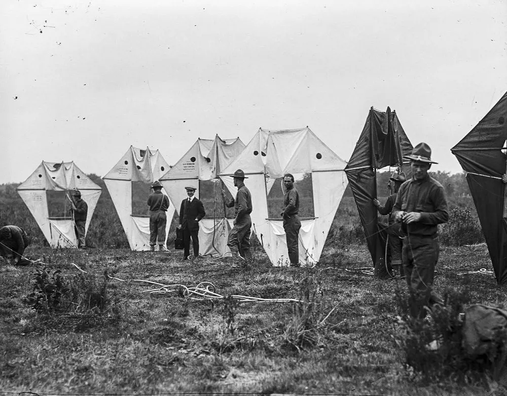 Vintage man lifting kites 