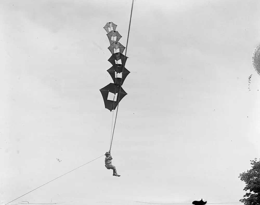 Vintage man lifting kites 