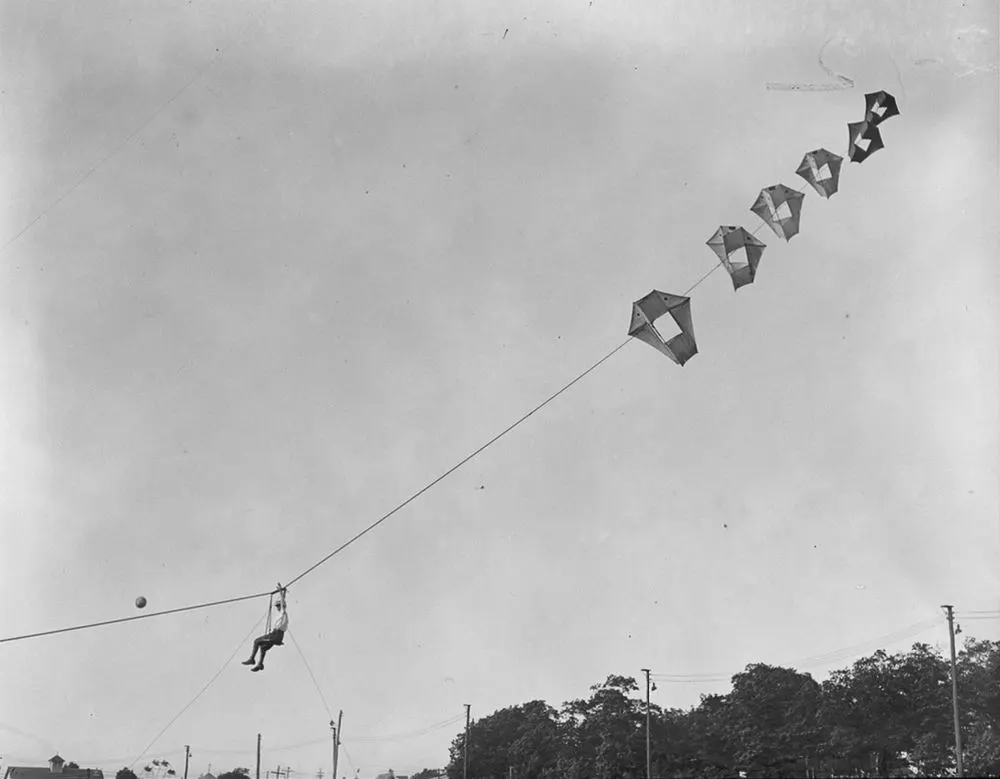 Vintage man lifting kites 