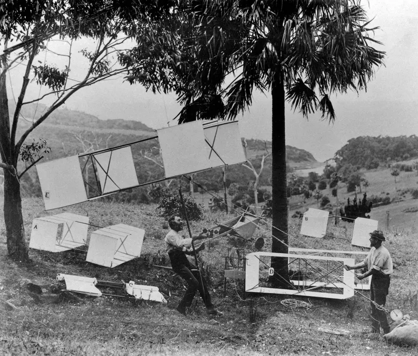 Vintage man lifting kites 