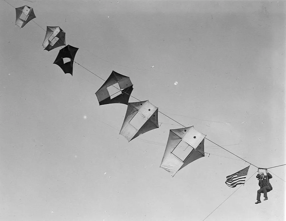 Vintage man lifting kites 
