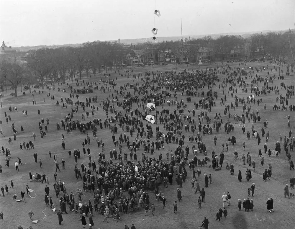 Vintage man lifting kites 