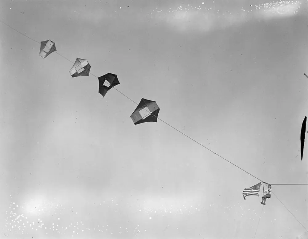 Vintage man lifting kites 