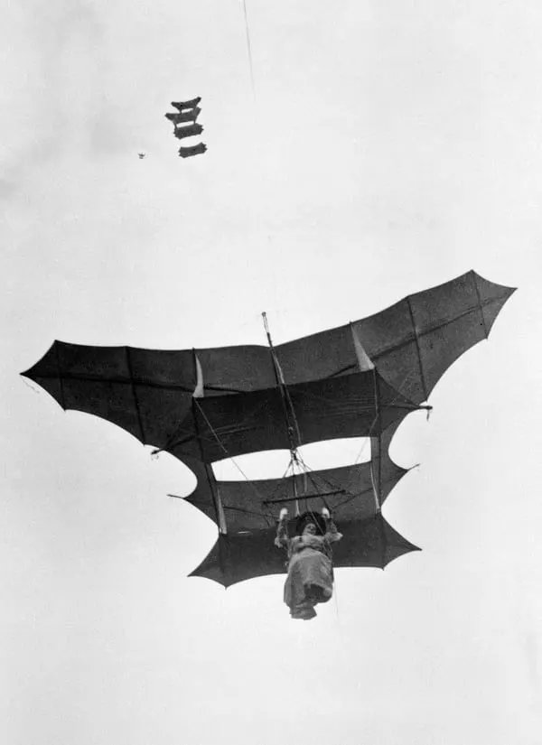Vintage man lifting kites 