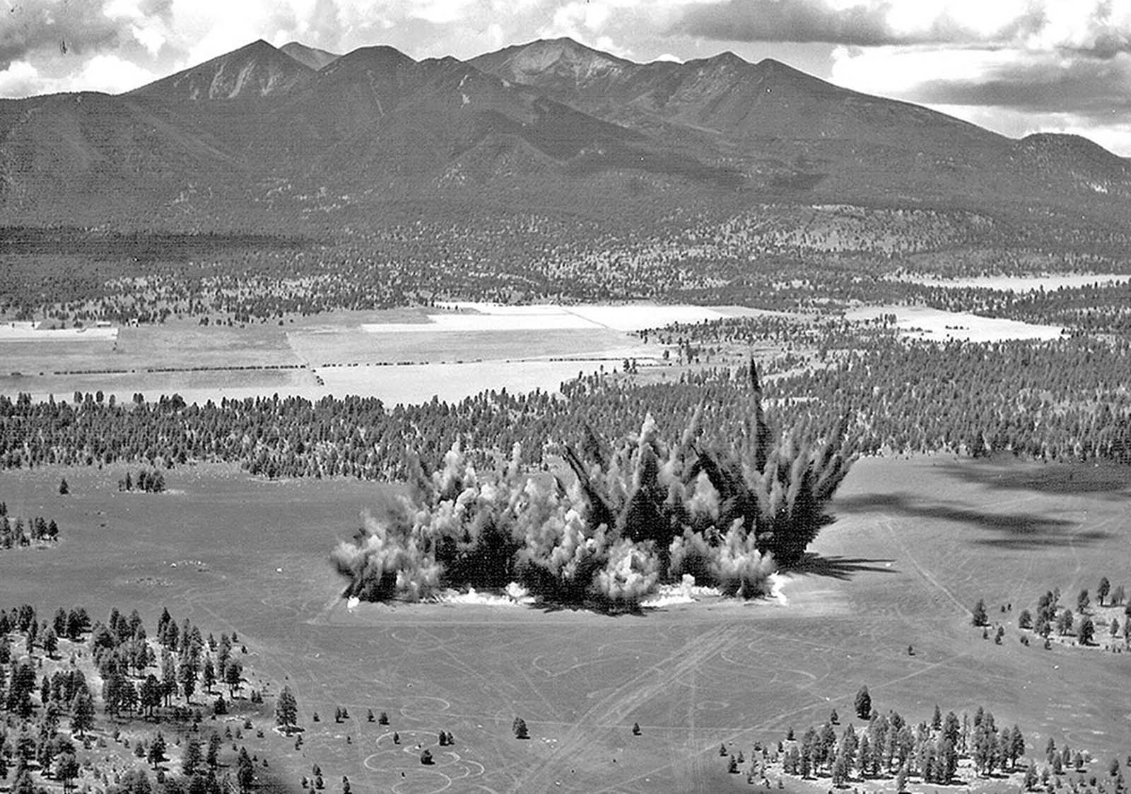 Explosions send dirt into the sky during the construction of Cinder Lake Crater Field #2 on July 27, 1968. A total of 354 craters were carved out of the Arizona landscape in this field to create a simulated lunar surface.