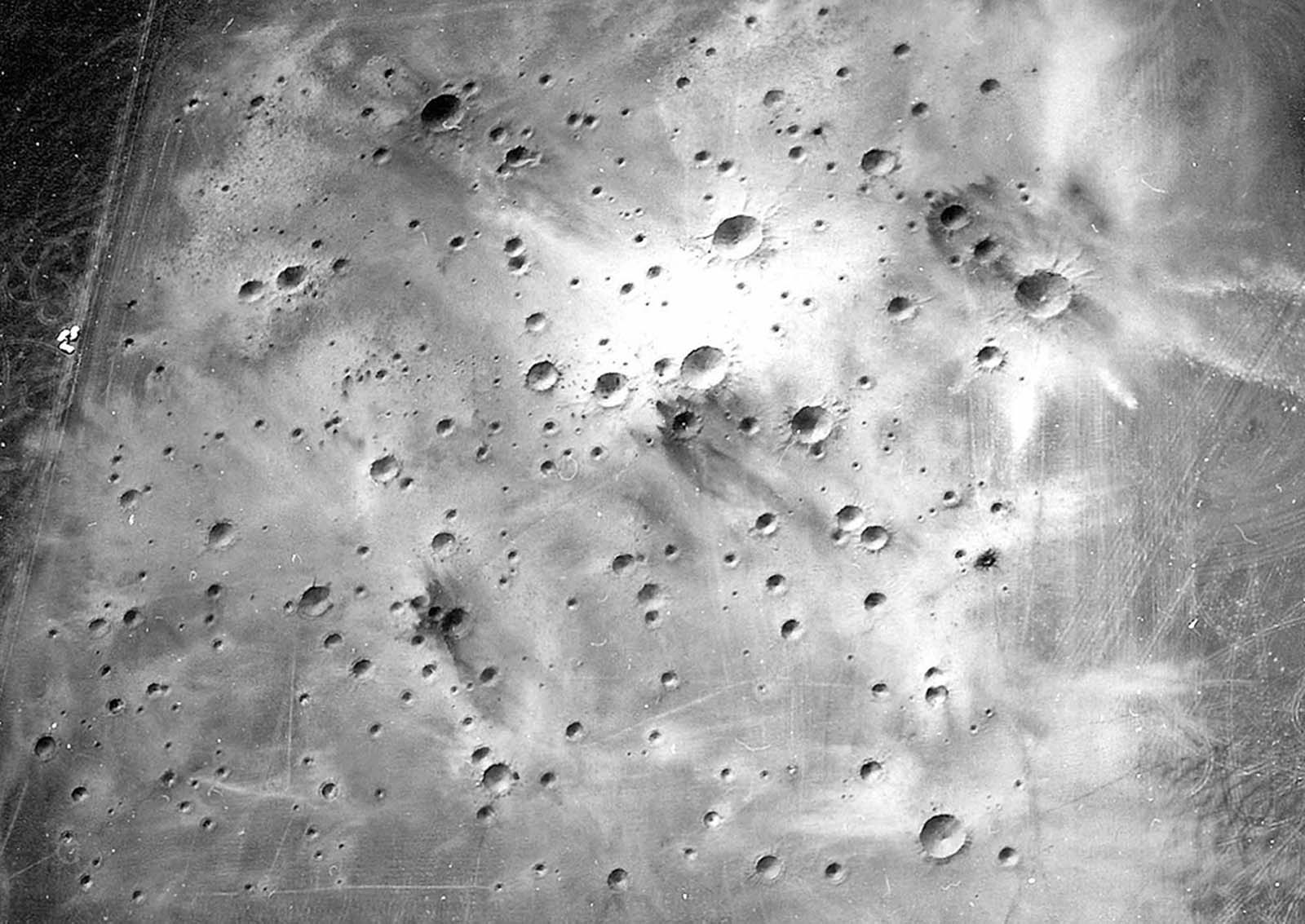 A post-explosion aerial view of the completed Cinder Lake Crater Field #2, showing very light ejecta caused by excavation of clay beds immediately below black basaltic cinders.