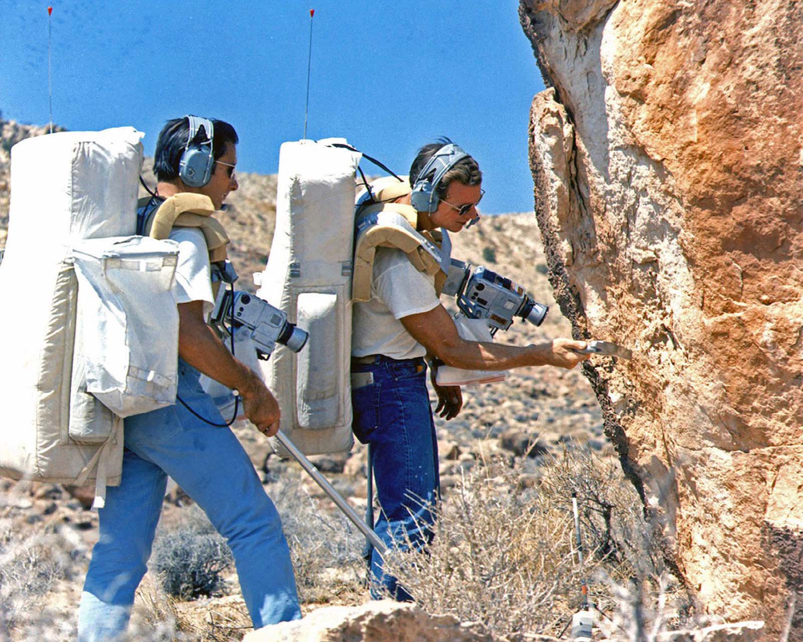 The astronauts Jim Irwin and Dave Scott check out an outcrop during the final geology exercise for the Apollo 15 prime and backup crew at Coconino Point, Arizona, on June 25, 1971. Both men went on to walk on the surface of the moon in 1971, during Apollo 15.