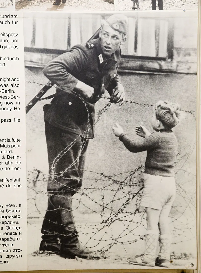 East German Soldier Helps a Little Boy Sneak Across the Berlin Wall, 1961